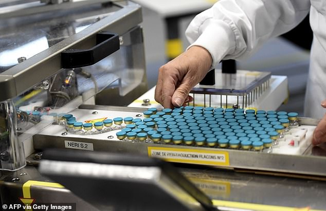 An employee works on a production line at the factory of British multinational pharmaceutical company GlaxoSmithKline (GSK) in Saint-Amand-les-Eaux, northern France